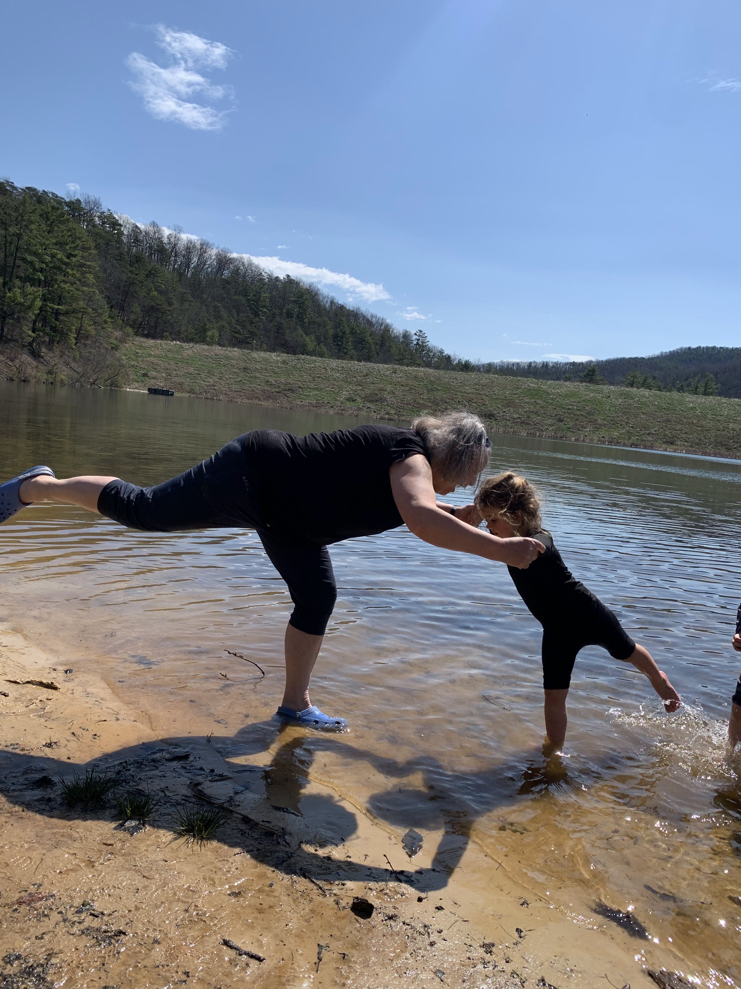 waterfront yoga teacher and child